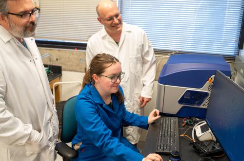 Three scientists viewing the results of a computational analysis