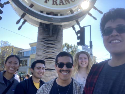 Group of people at the base of the Fisherman's Wharf sign in San Francisco