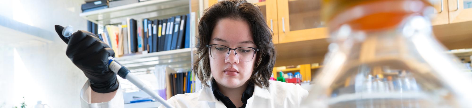 PREP scholar pipetting in a research lab